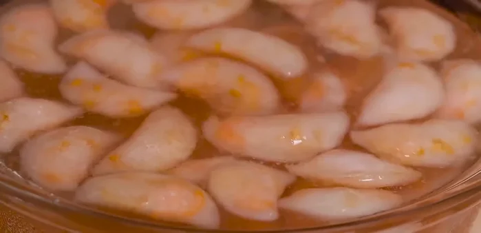 Cool the dumplings in cold water, then drain and toss with scallion oil.