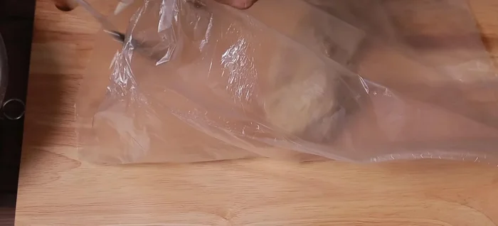 Shred the pork: While the meat is still warm, place it in a bag and use a rolling pin or wooden mallet to shred the pork into smaller pieces. Work quickly to prevent the meat from cooling.