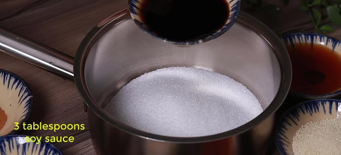 Prepare the spice mixture: In a bowl, combine 5 tbsp sugar, 3 tbsp soy sauce, 3 tbsp fish sauce, 2 tbsp seasoning powder, 1 tbsp annatto oil, a little turmeric powder (optional), 1/2 tsp garlic powder, 1/2 tsp five-spice powder, and 1/2 tsp cinnamon powder. Stir until the sugar dissolves.