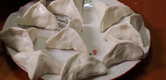 Fry the wrapped dough in a pan with oil until golden brown and crispy.