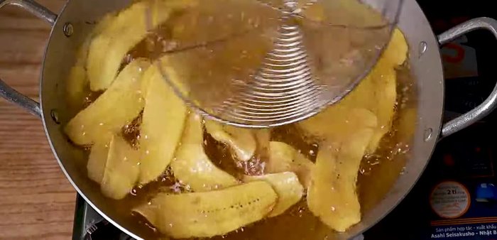 Once separated, gently press down the bananas with a spatula to ensure even cooking and crispiness.