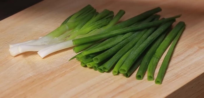 Finely chop green onions, then crush them to release fragrance.