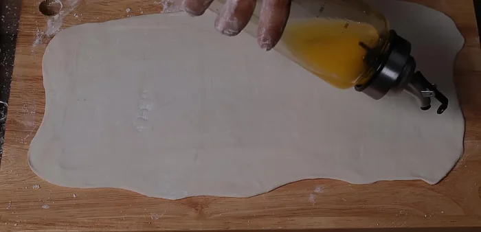 Spread butter (or cooking oil) evenly on the dough.