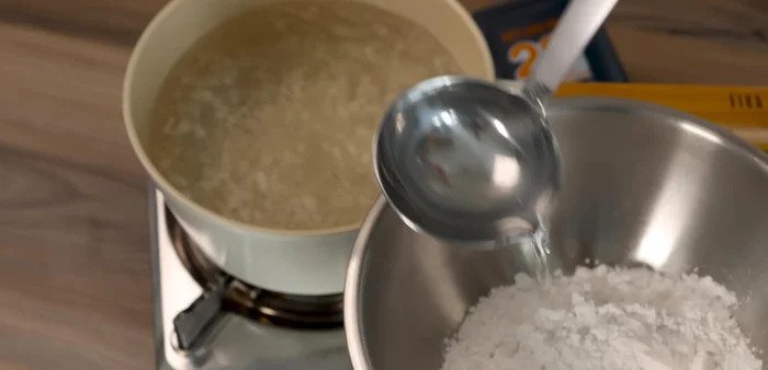 Make tapioca pearls: Mix 100g tapioca starch with 70g boiling water to form a dough. Let it cool slightly, then knead until smooth. Roll into a long log and cut into small pieces.