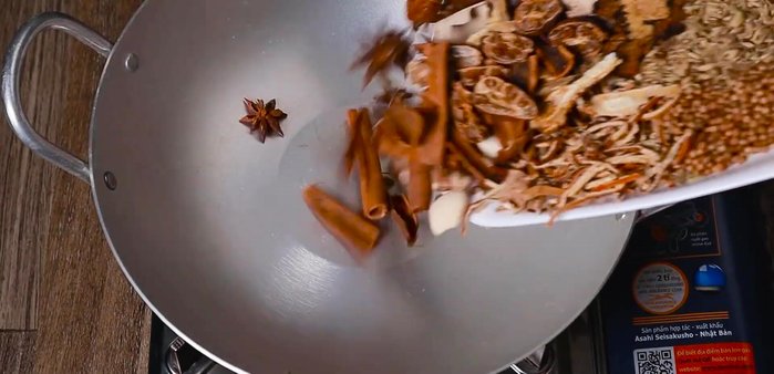 Add the larger ingredients to the hot pan, roasting until fragrant.