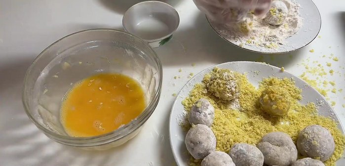 If using an egg wash, beat an egg and dip the flour-coated shrimp balls into the egg, then roll in the chosen coating again.
