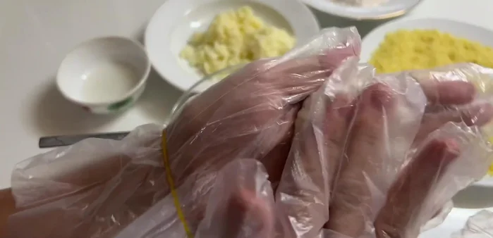 Form the shrimp mixture into balls, placing a piece of cheese in the center of each.