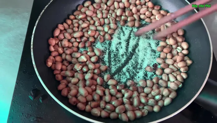 Roast peanuts with salt until golden brown. Wrap tightly in paper for 10-15 minutes to steam, then peel.