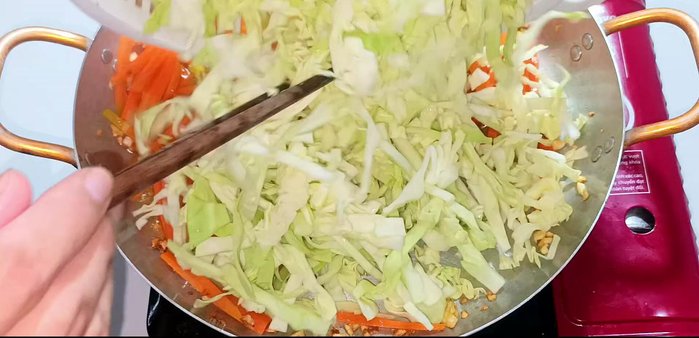 Add the cabbage (make sure it's drained) and stir-fry until softened.