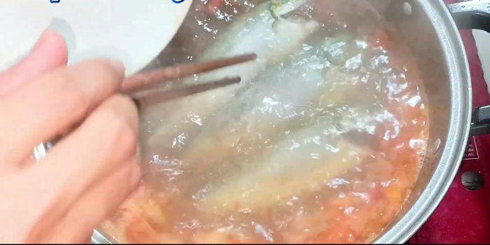 Add the fish and cook until the soup boils again. Boil for 2 minutes.