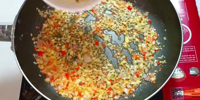 Add ground lemongrass and continue to stir-fry until golden and fragrant.
