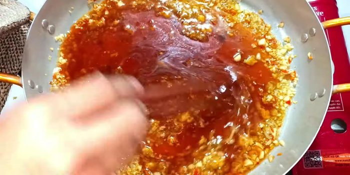 Add the tamarind sauce to the pan. Stir well and cook until the sauce boils.