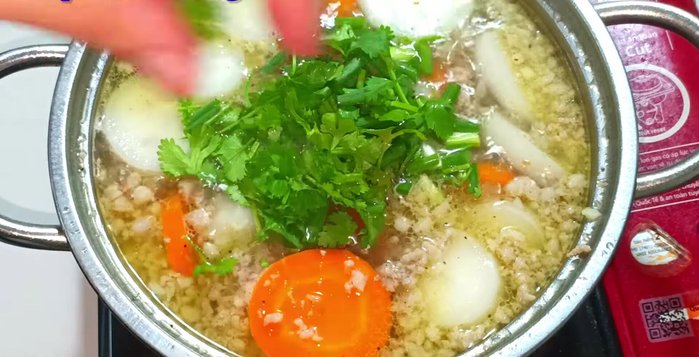 Stir well, bring to a boil again. Add green onions and cilantro. (256.12)