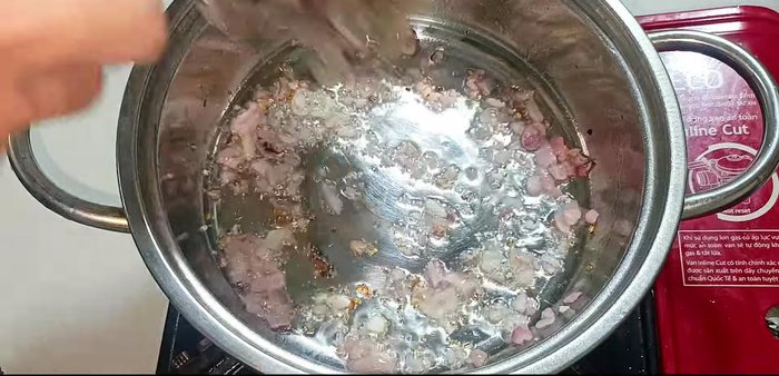Add the marinated shrimp to the pot and stir-fry briefly until they turn pink.