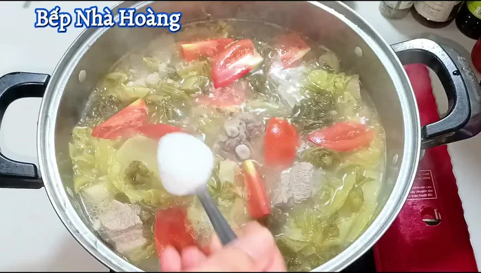 Reduce heat to low. Add 1 ½ cups of sugar (to balance the sourness of the pickled cabbage), ¼ teaspoon MSG, 1 spoonful of seasoning powder, and ¼ teaspoon salt. Stir well and adjust seasoning to taste.