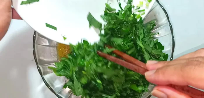 Add chopped lolot leaves and green onions to the egg mixture. Stir well.