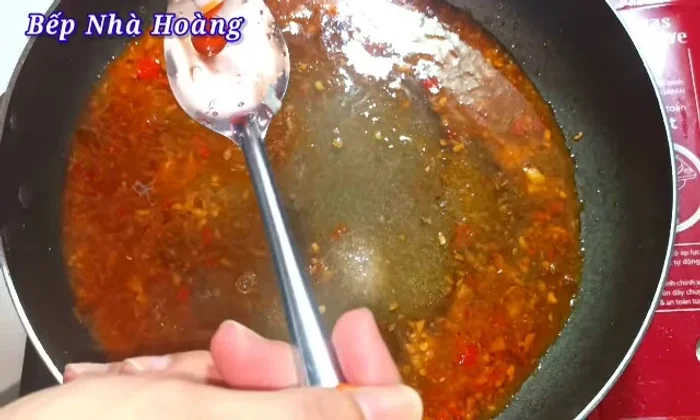 Add 1 tablespoon of fish sauce and 1 tablespoon of chili sauce. Stir to combine and dissolve the spices.