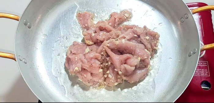 Heat cooking oil in a pan over medium heat. Stir-fry the marinated pork until cooked through and no longer pink.