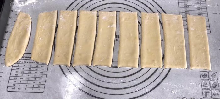 Dip a chopstick in water and lightly brush it between two dough strips to join them. Press gently to adhere.