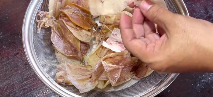 Cut or tear the dried squid into smaller, manageable pieces.