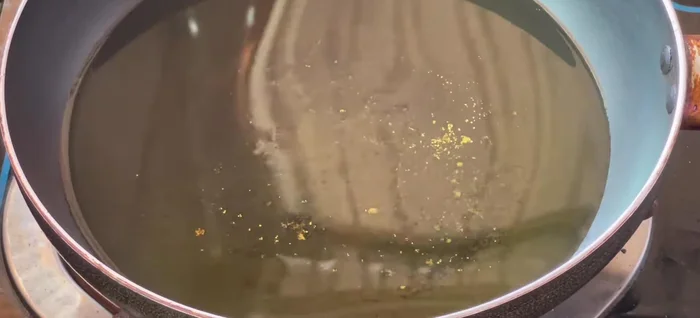Heat oil in a pan. Fry the squid in batches over medium heat for 15-20 seconds until golden brown. Remove and drain excess oil.