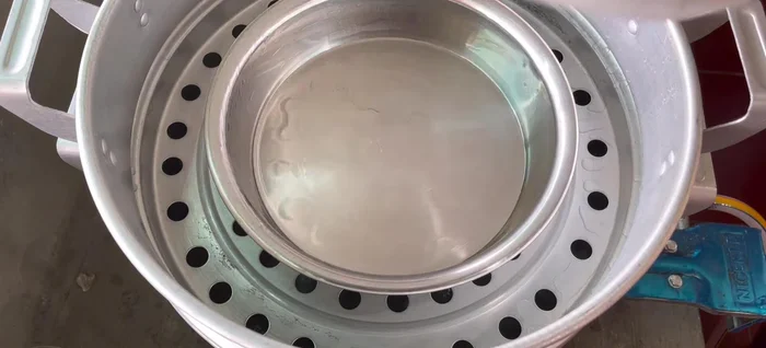 Prepare the mold: Grease a steamer mold and preheat it for a few minutes.