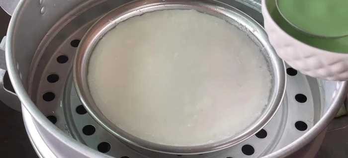 Steam the bottom layer until cooked, then add the green pandan layer on top. Steam for an additional 12-15 minutes.