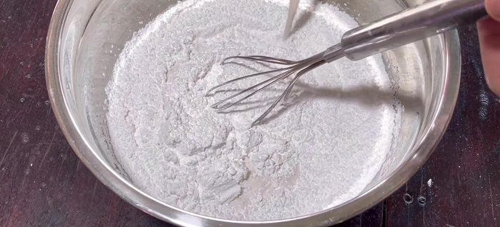 Add concentrated coconut milk and mix well. Gradually add hot water while stirring continuously to prevent lumps.