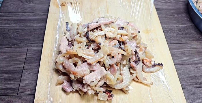 Prepare the plastic wrap and roll the meat mixture tightly. Use a Tam stick to remove air pockets and secure the ends with rubber bands.