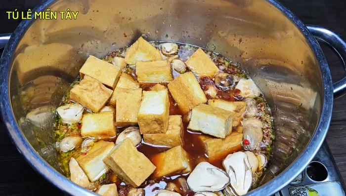 Add the straw mushrooms and tofu to the pot. Simmer for 10 minutes, allowing the ingredients to soak in the spices.