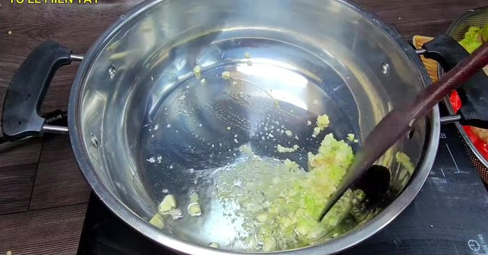 Prepare the sauce: Heat cooking oil in a pot. Add minced lemongrass and garlic; fry until fragrant. Add pineapple pieces and stir-fry. Pour in coconut water, soy sauce, MSG, sugar, salt, and minced garlic.