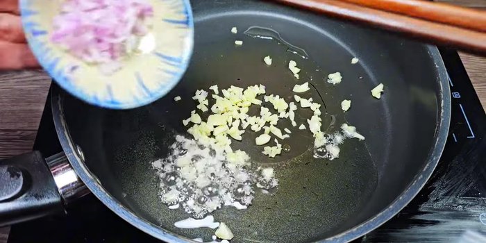 Add garlic and shallots to the pan and saute.