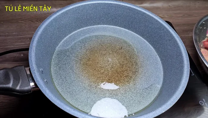 Heat cooking oil in a frying pan. Once hot, fry the pork chops in batches until golden brown on all sides, ensuring even browning by turning frequently over medium heat.