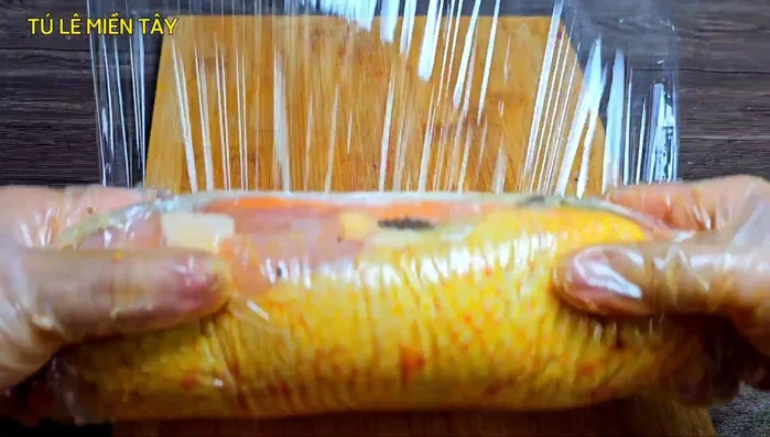 Roll up the chicken tightly, securing the ends with plastic wrap and rubber bands. Roll multiple times to ensure a compact shape.