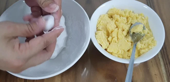 Cut the dough into small pieces, shape them into small balls, and fill with mung bean filling.