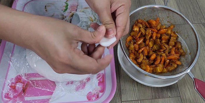 Assemble the dumplings: Roll out the dough and place a spoonful of filling in the center. Fold the dough over and pinch the edges to seal.