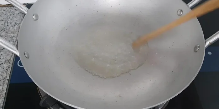 Braise the fish: Heat a little cooking oil in a pot. Add sugar and stir until it turns slightly yellow. Add garlic and shallots and fry until fragrant. Add the fish, half a cup of water, and the remaining marinade. Simmer over low heat, occasionally turning the fish, until cooked through.