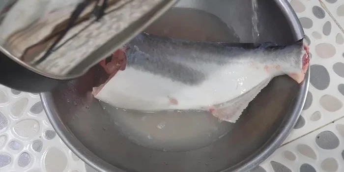 Clean the fish: Rinse the fish under hot water (not too hot) to remove slime. Scrape off any black parts on the skin. Rub the fish with a mixture of lemon and salt to remove fishy smell and further clean the fish.