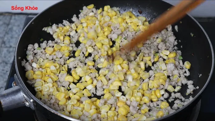 Add the corn and stir-fry. Season with sugar, seasoning powder, and ground pepper to taste.