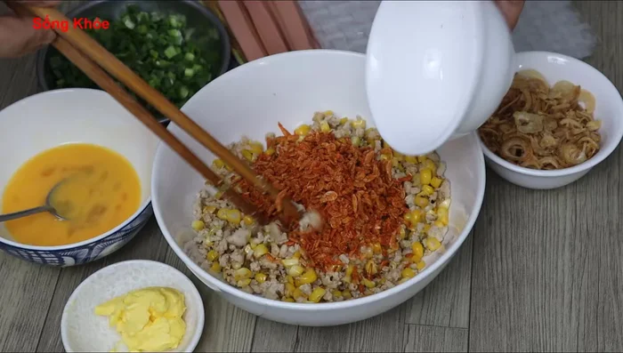 Spread the filling onto thin rice paper, including dried shrimp (if using), green onion leaves, and fried onions.