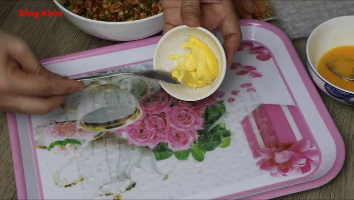Spread butter evenly on the rice paper edges for easier rolling. Spread the remaining egg on the non-buttered edges for added softness.