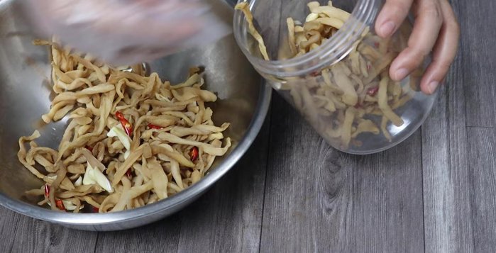 Place the drained and dried radish into a clean jar. Pour the cooled soaking liquid over the radish, ensuring it's fully submerged. Add garlic and chili if using.