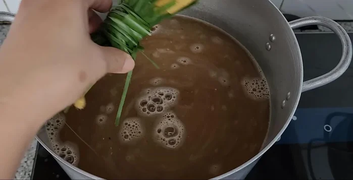 Crush wormwood and a lemongrass stalk; tie them together and add to the broth.
