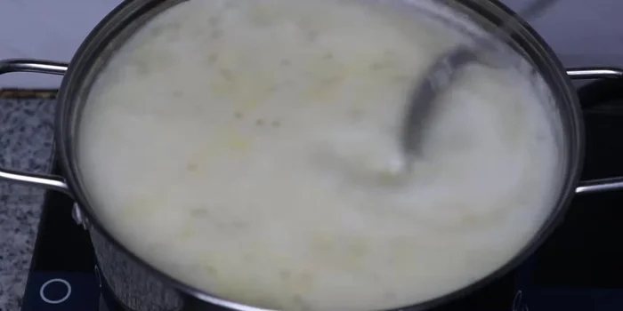 Add the remaining coconut milk, bring to a boil, and stir well.