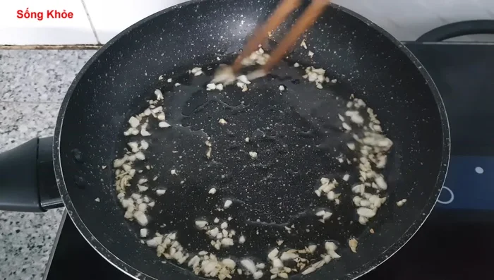Add the marinated pork to the wok and stir-fry until golden brown.