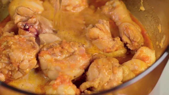 Add coconut water and water to the chicken. Skim off the foam and lower the heat to medium. Cook until chicken is soft.