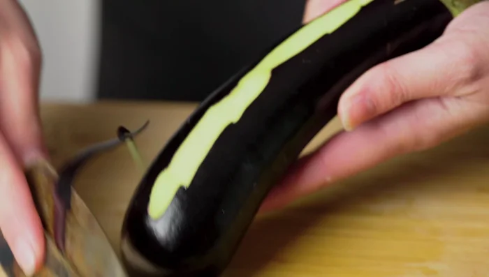 Peel eggplants, soak in salted water to prevent browning.