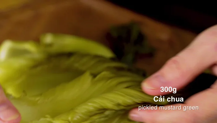 Cut pickled mustard greens into bite-sized pieces.