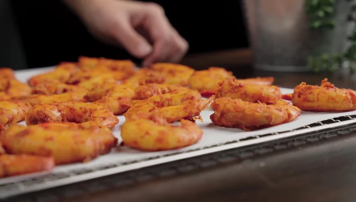 Arrange shrimp on a wax paper-lined tray and dry in the oven at 60-65°C (140-149°F) for 4-6 hours, or dry in the sun for a shorter time.