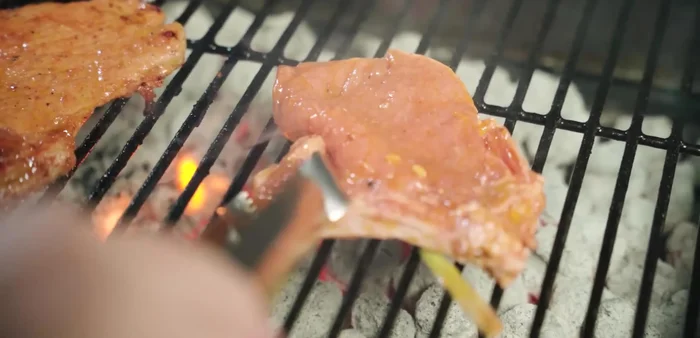 Grill the marinated pork chops over charcoal or in an air fryer (375°F for 8-10 minutes).